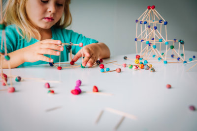 Little girl making geometric shapes, engineering and STEM